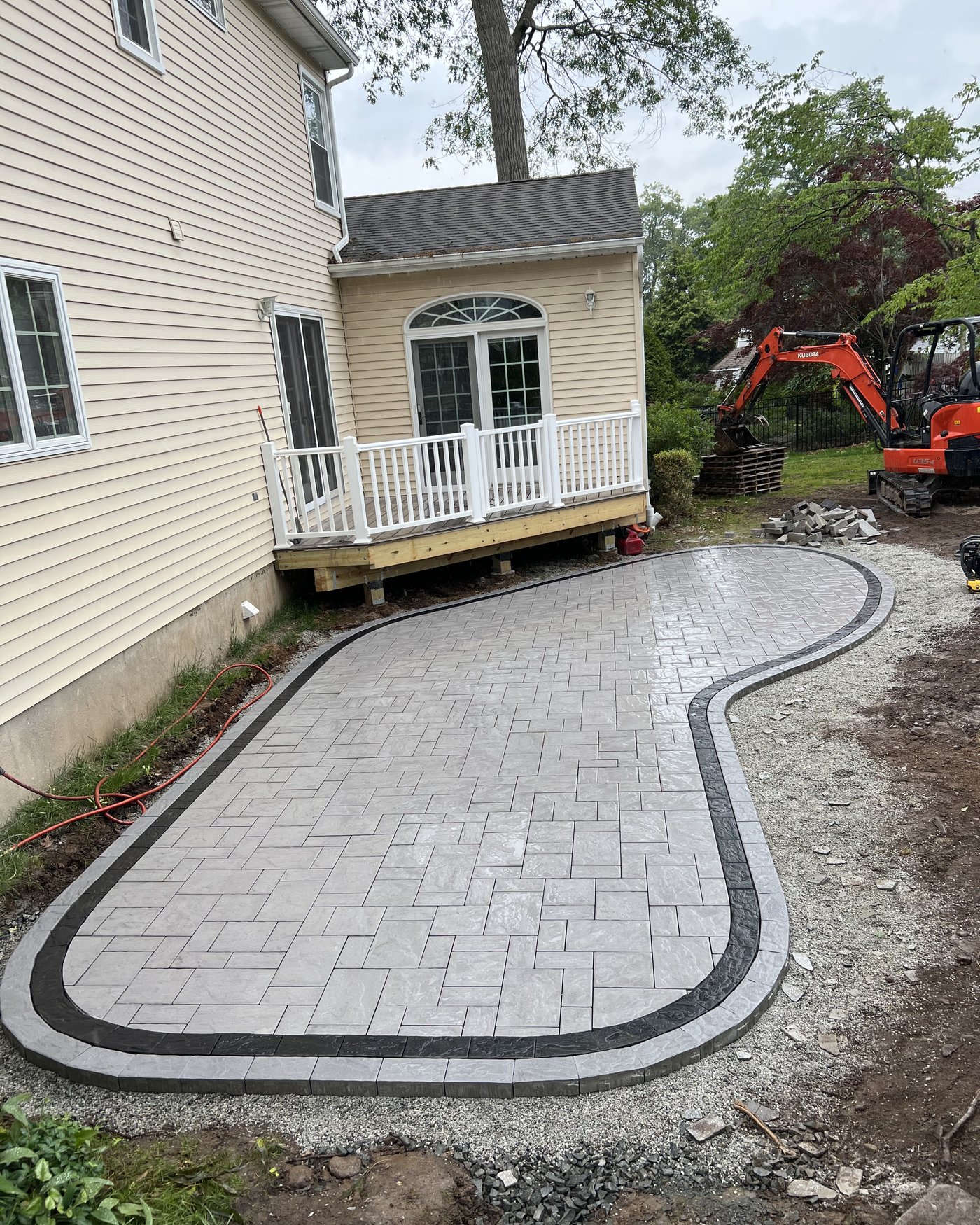 Custom two-tone paver patio with dark border