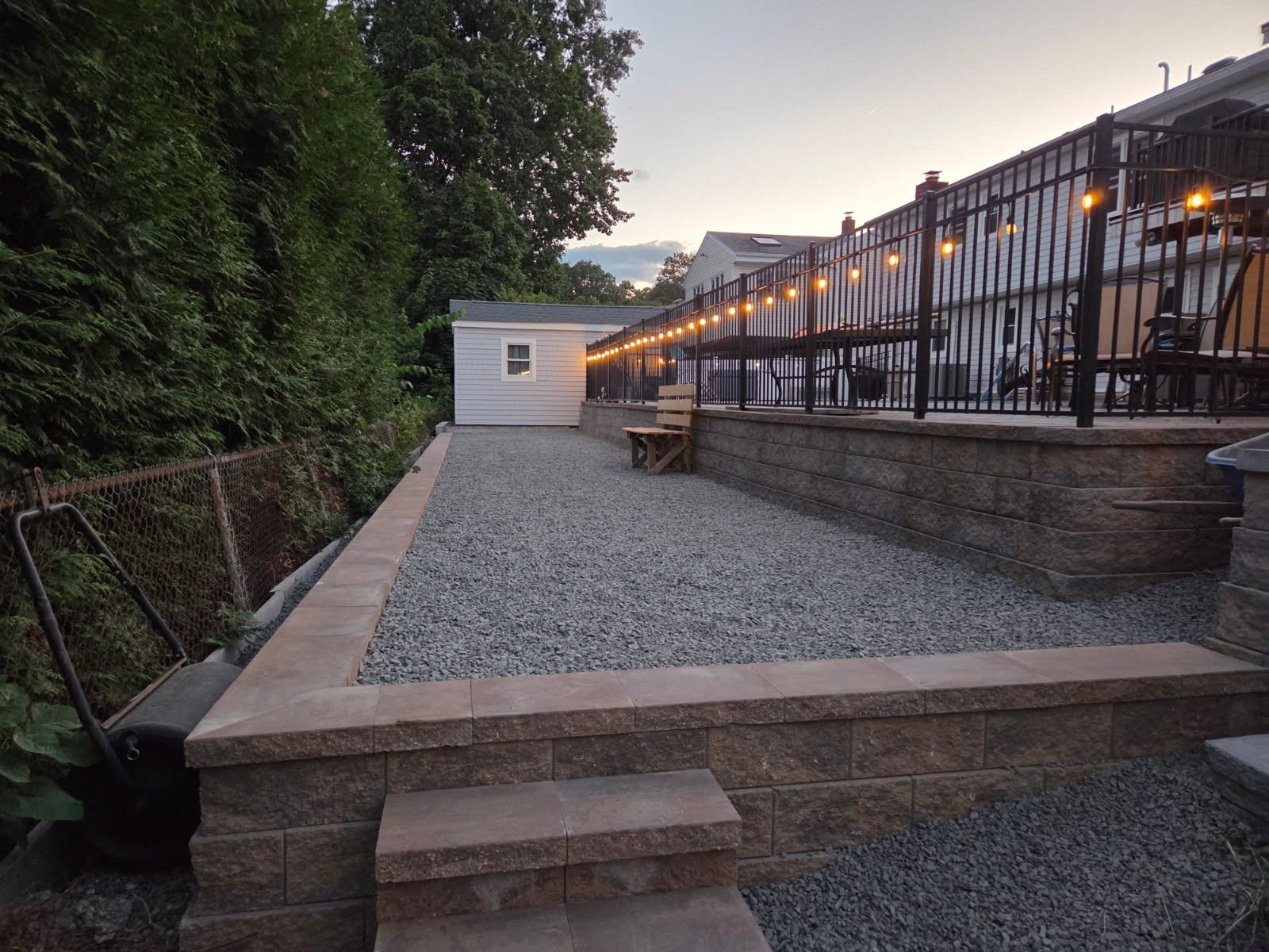 Sunset shot of layered hardscape with string lights