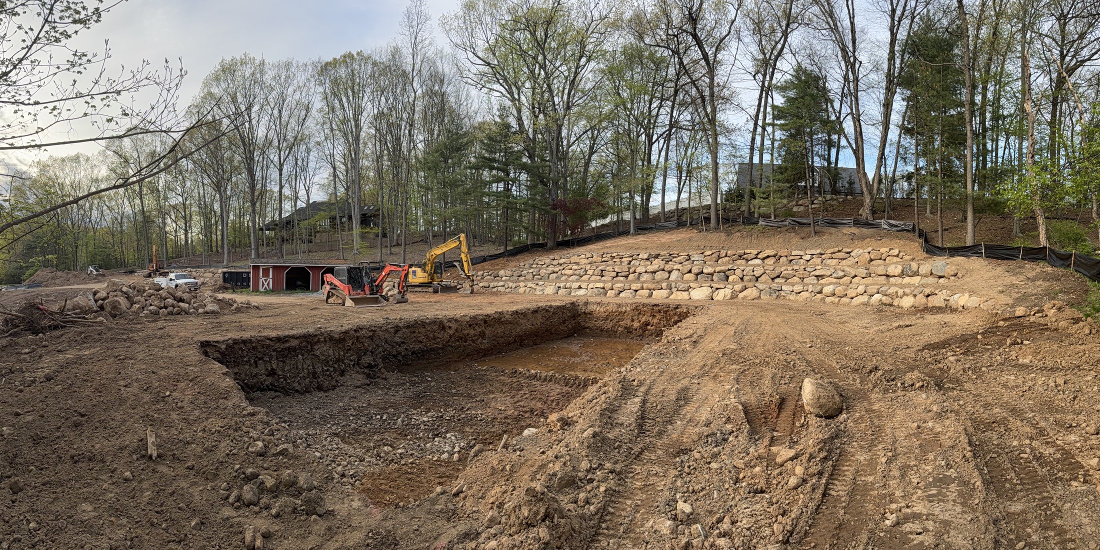 Multi-tier boulder retaining wall installation
